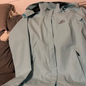 OTU WOMENS SMALL BLUE RAIN JACKET. NEVER WORN